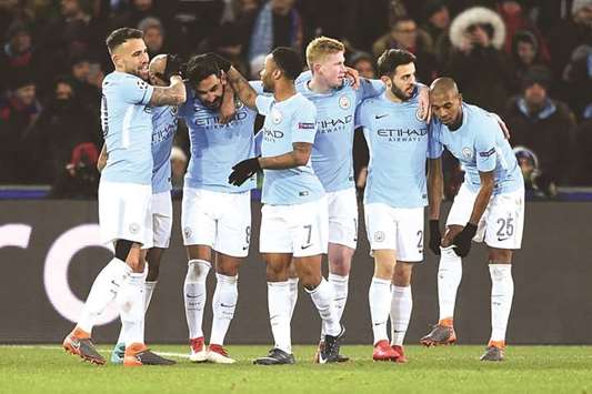 Manchester Cityu2019s German midfielder Ilkay Gundogan (third from left) celebrates with teammates after scoring his second goal during the UEFA Champions League round of 16 first leg match against Basel at the Saint Jakob-Park Stadium in Basel yesterday. (AFP)