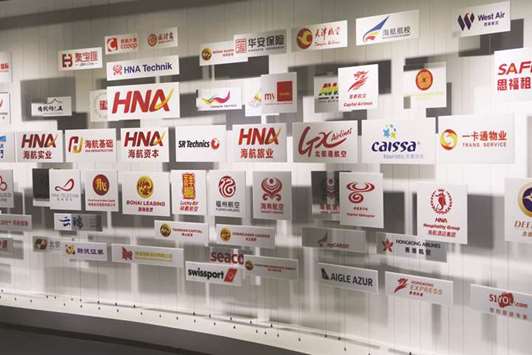 Logos are seen at the HNA museum within the headquarters of HNA Group in Haikou, Hainan province. Some HNA Group board directors and senior managers have bought offshore dollar bonds guaranteed by the Chinese conglomerate in the latest effort to shore up its finances.