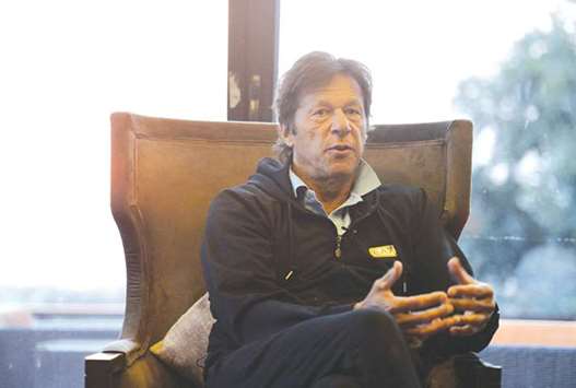 Pakistan Tehreek-i-Insaf (PTI) head Imran Khan speaks during an interview with AFP at his home in Islamabad.