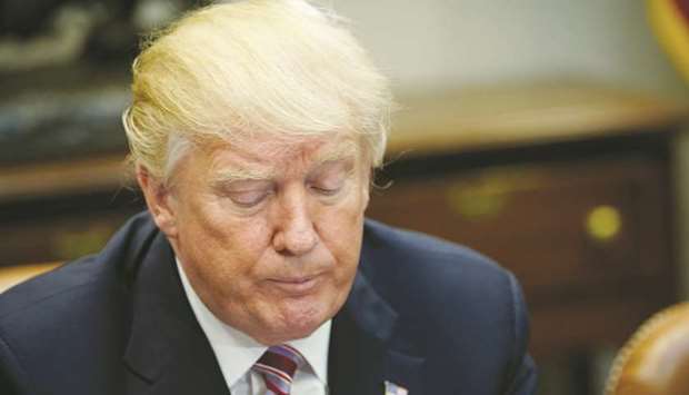 US President Donald Trump pauses during a roundtable discussion with members of the National Sheriffsu2019 Association in the Roosevelt Room of the White House on February 13, 2018 in Washington, DC.