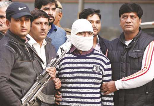 Plainclothes policemen present Ariz Khan, who police claim is a member of Indian Mujahideen militant group, to the media after his arrest, in New Delhi yesterday.