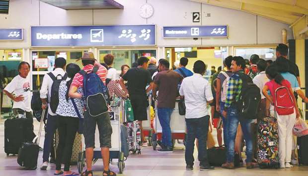 Tourists wait in the departures hall at Velana International Airport in Male yesterday.