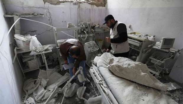 Syrian medics check the damage at the ,Sham Surgical, hospital, in the northwestern town of Hass on Thursday.