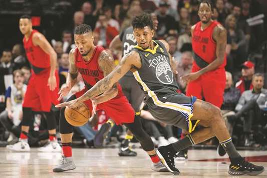 Portland Trail Blazers guard Damian Lillard (left) snatches the ball away from Golden State Warriors guard Nick Young during the NBA match. (USA TODAY Sports)