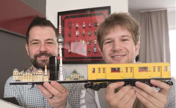 MODELS: Lego collector Stephan Birner, left, shows off a model of the Berlin skyline, while Felix Fleischer displays a Berlin underground train. They are both members of a club in Berlin dedicated to the bricks that generations have grown up with. DPA