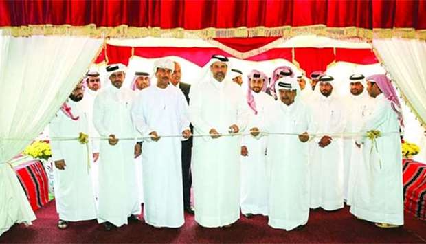 HE the Minister of Economy and Commerce Sheikh Ahmed bin Jassem bin Mohamed al-Thani inaugurates the Seasonal Dates Market as Qatari Businessmen Association chairman HE Sheikh Faisal bin Qassim al-Thani and other dignitaries look on.