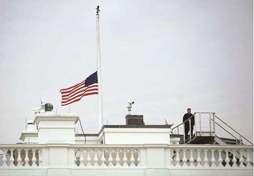 The flag above the White House flies at half staff yesterday after an order by President Donald Trump following the Florida school shooting.