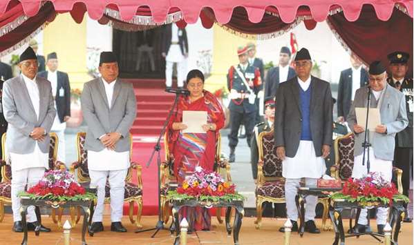 Nepalu2019s newly-elected Prime Minister KP Sharma Oli (right) is sworn in by President Bidhya Bhandari as Vice President Nanda Kishor Pun (second left), outgoing prime minister Sher Bahadur Deuba and Chief Justice Gopal Parajuli look on at the Presidentu2019s House in Kathmandu.