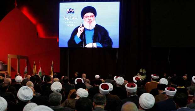 Lebanon's Hezbollah leader Sayyed Hassan Nasrallah is seen on a video screen as he addresses his supporters in Beirut