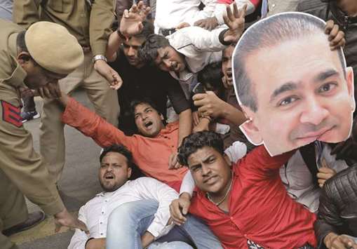 An activist of the youth wing of the Congress party holds a cut-out with an image of billionaire jeweller Nirav Modi during a protest in New Delhi yesterday.