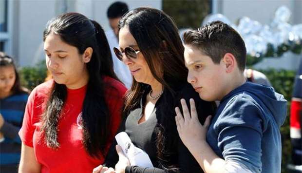 Students and parents from Marjory Stoneman Douglas High School attend a memorial following a school shooting incident in Parkland, Florida.