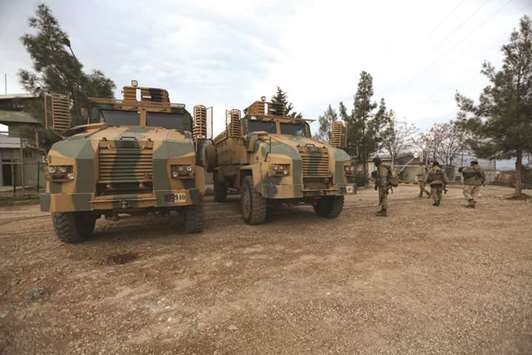 Turkish-backed Free Syrian Army fighters are seen next to military trucks in Northern Afrin countryside, yesterday.