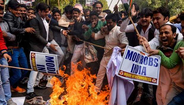 Protesters shout slogans as they burn effigy of billionaire jeweller Nirav Modi in New Delhi