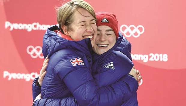 Bronze medallist Great Britainu2019s Laura Deas (right) and gold medallist Great Britainu2019s Lizzy Yarnold hug after the womenu2019s skeleton event of the Winter Olympic Games in Pyeongchang. (AFP)
