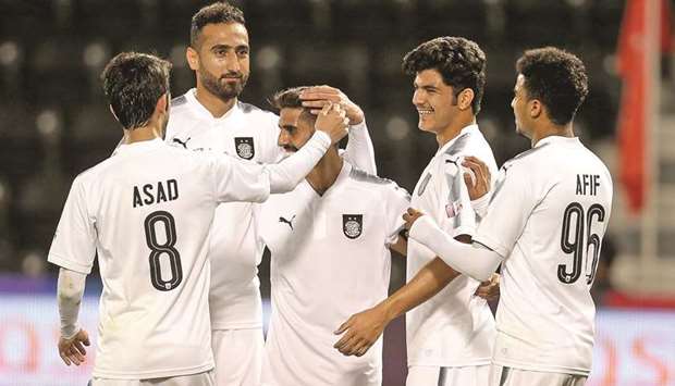 Hassan al-Haydous is congratulated by teammates on scoring his hat-trick goal yesterday.