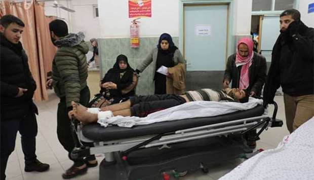 An injured Palestinian man arrives to receive treatment at a hospital in Rafah following an Israeli air strike on the enclave.