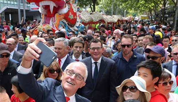 Australian Prime Minister Malcolm Turnbull takes a selfie as he walks with Victorian Premier Daniel Andrews and members of the public during a parade as part of the Chinese New Year Festival in Melbourne on Sunday.