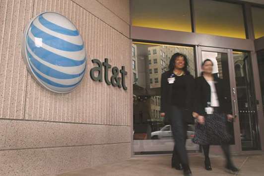 AT&T employees walk out of the companyu2019s corporate headquarters in San Antonio, Texas (file). AT&T is trying to learn if there was any political tampering in the departmentu2019s November lawsuit to stop the $85.4bn merger, which the agency has said would harm consumers.
