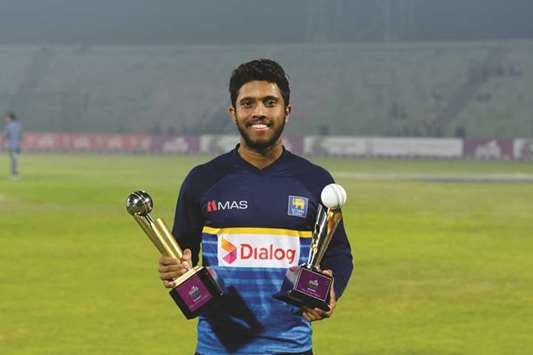 Sri Lankau2019s Kusal Mendis poses with his man-of-the match and man-of-the-series trophies after the second Twenty20 match against Bangladesh in Sylhet, Bangaldesh. (AFP)