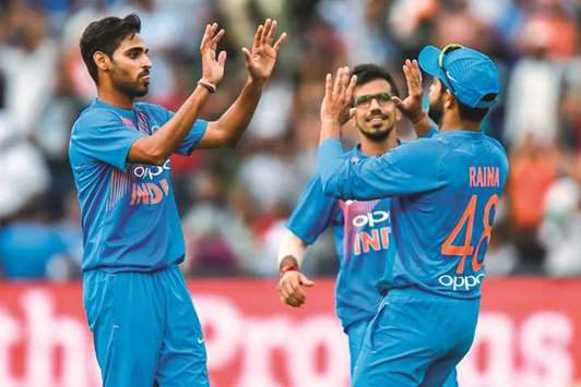 Indiau2019s Bhuvneshwar Kumar (left) celebrates with teammate Suresh Raina (right) after dismissing South African batsman Chris Morris (not in the picture) during the first T20 match at the Wanderers Cricket Stadium in Johannesburg yesterday. (AFP)