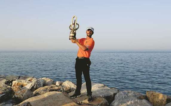 Joost Luiten of the Netherlands celebrates with the trophy after winning the NBO Oman Open at Al Mouj Golf in Muscat yesterday.