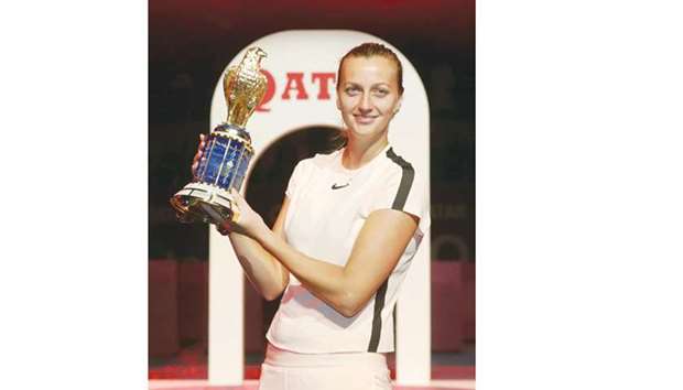 Petra Kvitova of the Czech Republic poses with the Qatar Total Open trophy after her win over Garbine Muguruza in the final in Doha yesterday. PICTURE: Jayan Orma