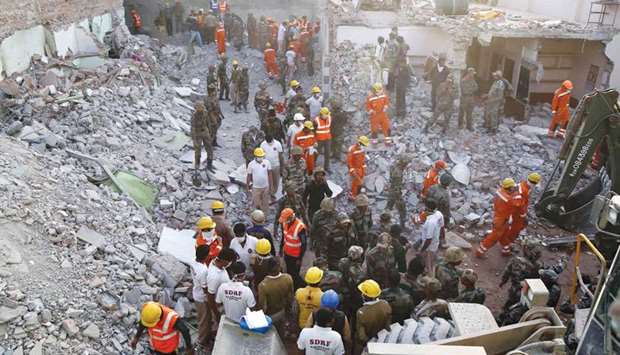 Recovery teams sifting through mangled heaps of concrete and steel after a building collapsed due to a gas cylinder blast during wedding party in Beawar Rajasthan, yesterday.