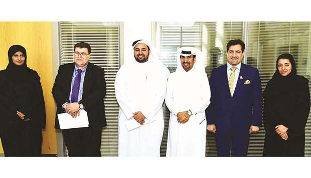 QU and Ooredoo Qatar officials after announcing the conference.