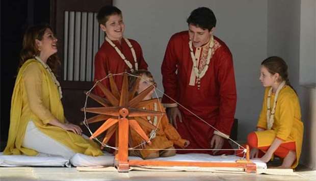 Canadian Prime Minister Justin Trudeau and his wife Sophie Gregoire sit with their daughter Ella-Grace and their sons Xavier and Hadrien as they try out a ceremonial spinning wheel during their visit to Gandhi Ashram in Ahmedabad on Monday.
