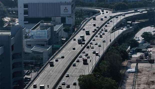 Motorists drive on an elevated highway in Singapore on Monday. Singapore will impose a carbon tax from next year.