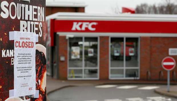 A closed sign hangs on the drive through of a KFC restaurant after problems with a new distribution system in Coalville
