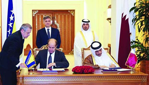 HE the Prime Minister and Interior Minister Sheikh Abdullah bin Nasser bin Khalifa al-Thani and the Chairman of the Council of Ministers of Bosnia and Herzegovina Denis Zvizdic witness the signing of an agreement between the govenments of Qatar and Bosnia and Herzegovina at the Emiri Diwan.