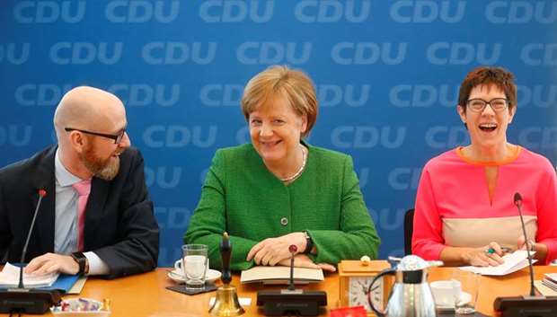 Secretary General of the Christian Democratic Union (CDU) Peter Tauber, German Chancellor Angela Merkel and Saarland State Prime Minister Annegret Kramp-Karrenbauer attend a CDU leadership meeting in Berlin yesterday.