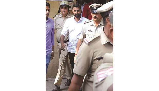 Police escort Karnataka Congress legislator N A Harisu2019 son and expelled state Youth Congress leader Mohamed Nalapad as he is produced before a court in Bengaluru yesterday.