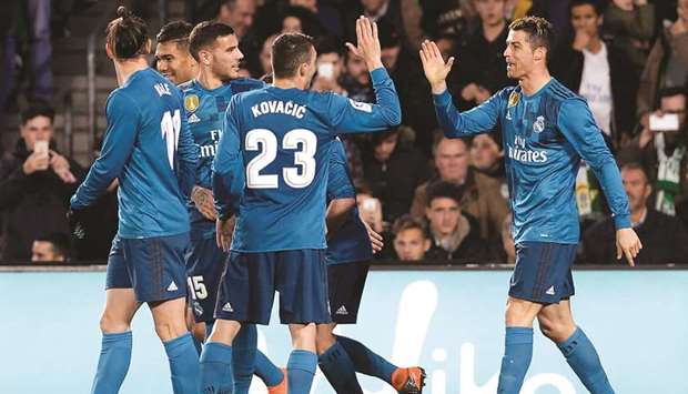 Real Madridu2019s Portuguese forward Cristiano Ronaldo (right) celebrates scoring a goal with teammates during the LA LiGa match against Real Betis at the Benito Villamarin stadium in Sevilla yesterday. (AFP)