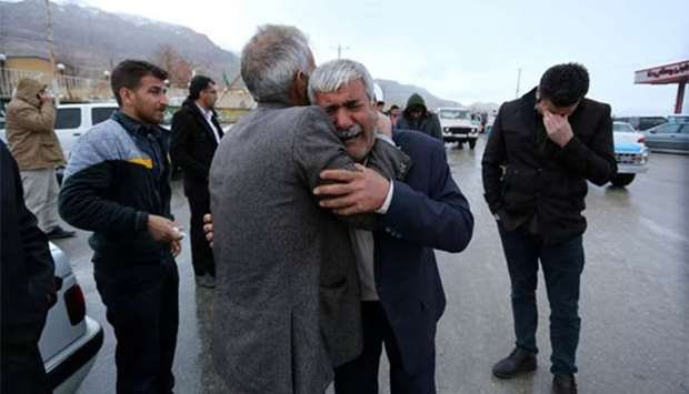 Relatives of passengers who were believed to have been killed in a plane crash react near the town of Semirom, Iran on Sunday.