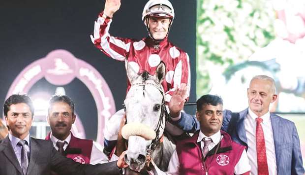 In this December 30, 2017, picture, trainer Alban de Mieulle (right) and Olivier Peslier (centre) celebrate after Umm Qarnu2019s Yazeed won the Qatar Derby. PICTURE: Juhaim