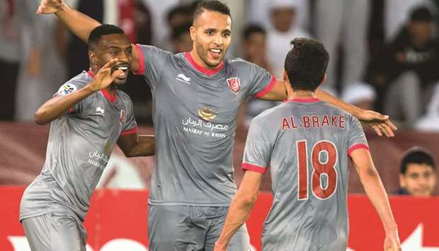 Al Duhailu2019s Youssef El Arabi (centre) celebrates with his teammates after scoring a goal during the AFC Champions League match against Al Wahda in Abu Dhabi yesterday. (AFP)