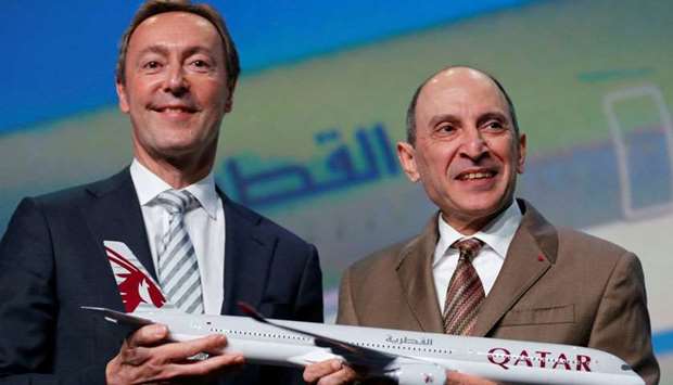 Airbus Chief Operating Officer President Fabrice Bregier and Qatar Airways Chief Executive Akbar Al Baker hold a scale model of a Qatar Airways Airbus A350-1000 during a news conference in Blagnac near Toulouse, France