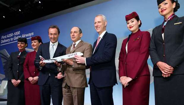 Al-Baker with Bru00e9gier and Chorleton holding a scale model of worldu2019s first Airbus A350-1000 in Qatar