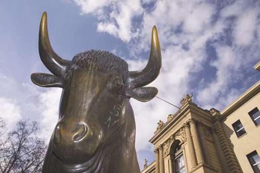 A statue of a bull is seen outside the Frankfurt Stock Exchange. The DAX 30 closed 0.8% up at 12,487.90 points yesterday.