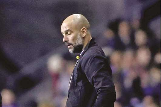 Manchester City manager Pep Guardiola looks dejected after their FA Cup defeat against Wigan Athletic. (Reuters)