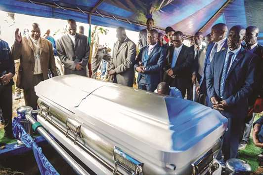 Movement for Democratic Change party members pay their respects around the coffin of Morgan Tsvangirai during the burial at his rural village Humanikwa in Buhera.
