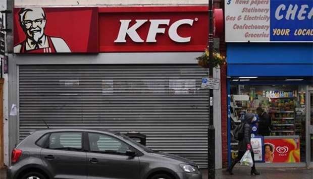 Pedestrians pass outside a closed KFC fast food store in south London earlier this week.