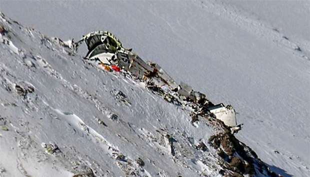 The wreckage of a plane that crashed near a mountain peak is seen in Iran's Zagros mountain range.