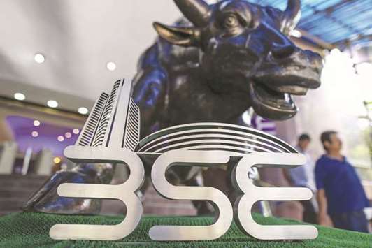 Signage for the Bombay Stock Exchange is displayed at the entrance to the BSE building in Mumbai. The Sensex closed up 141.27 points to 33,844.86 yesterday.