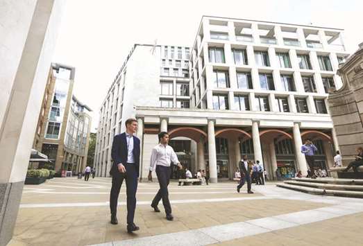 Pedestrians pass the London Stock Exchange offices in Paternoster Square in London. The FTSE 100 closed up 0.5% to 7,281.57 points yesterday.