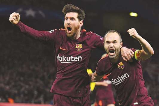Barcelonau2019s star striker Lionel Messi (left) celebrates with midfielder Andres Iniesta after scoring during the first leg of the UEFA Champions League round of 16 match against Chelsea at Stamford Bridge stadium in London on Tuesday night. (AFP)