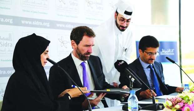 Sidra Medicine and CCQ officials at the MoU signing