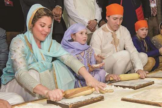 Canadian Prime Minister Justin Trudeau, his wife Sophie Gregoire Trudeau, daughter Ella-Grace and son Xavier prepare chappati at a community kitchen at the Golden Temple in Amritsar yesterday.